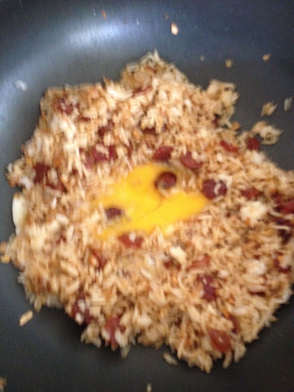 Beat an egg to the rice mixture. Wait a minute or two and then fluff the rice quickly to ensure they are well coated with egg