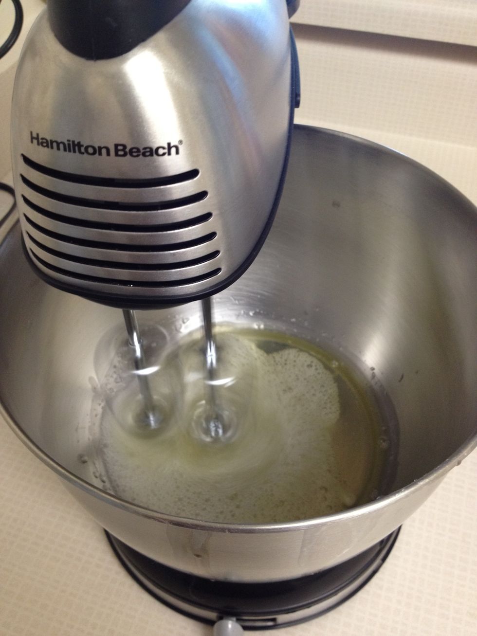 Beat egg whites at medium-high speed until they hold stiff peaks. Add 1/4 cup of sugar a little at a time.