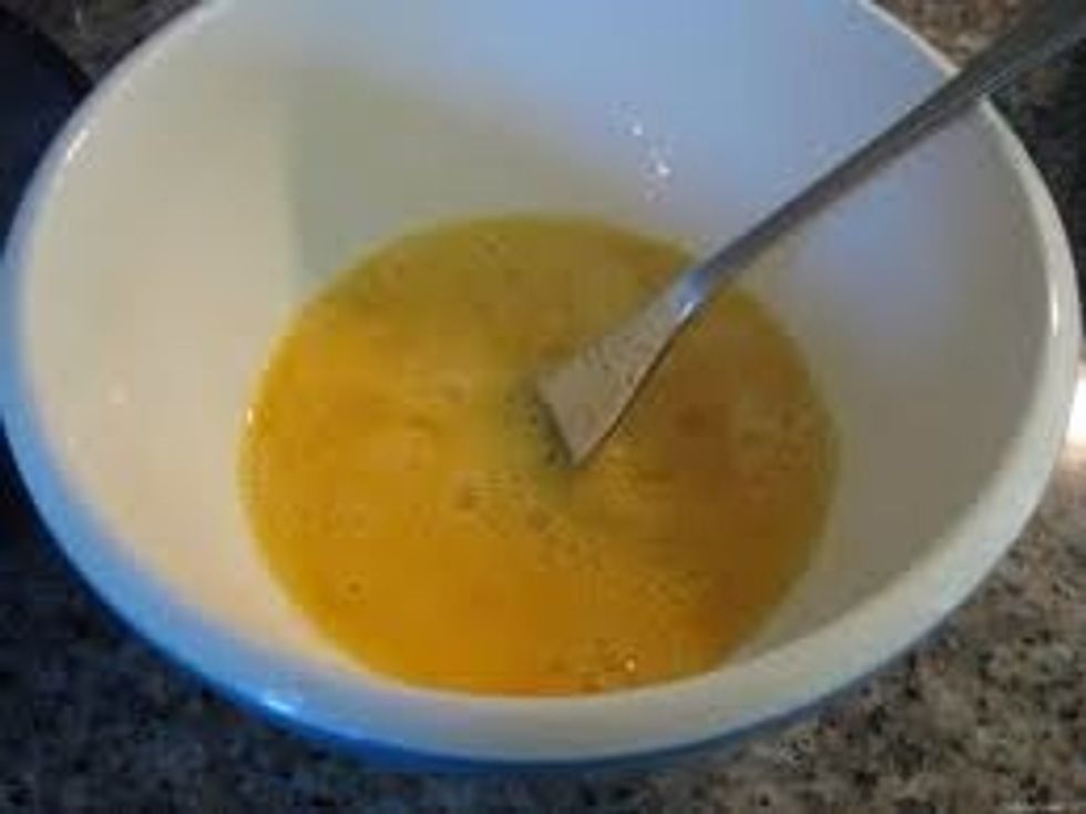 Beat eggs and then add milk. After that beat eggs some more.