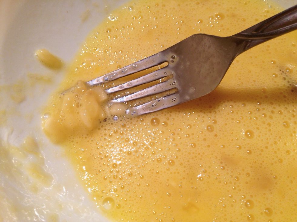 Beat in the eggs. The texture will smoother out, but it's okay if there's the occasional lump!