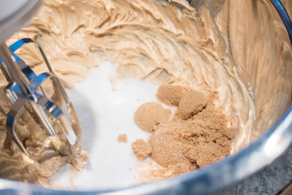 Beat peanut butter and sugars together