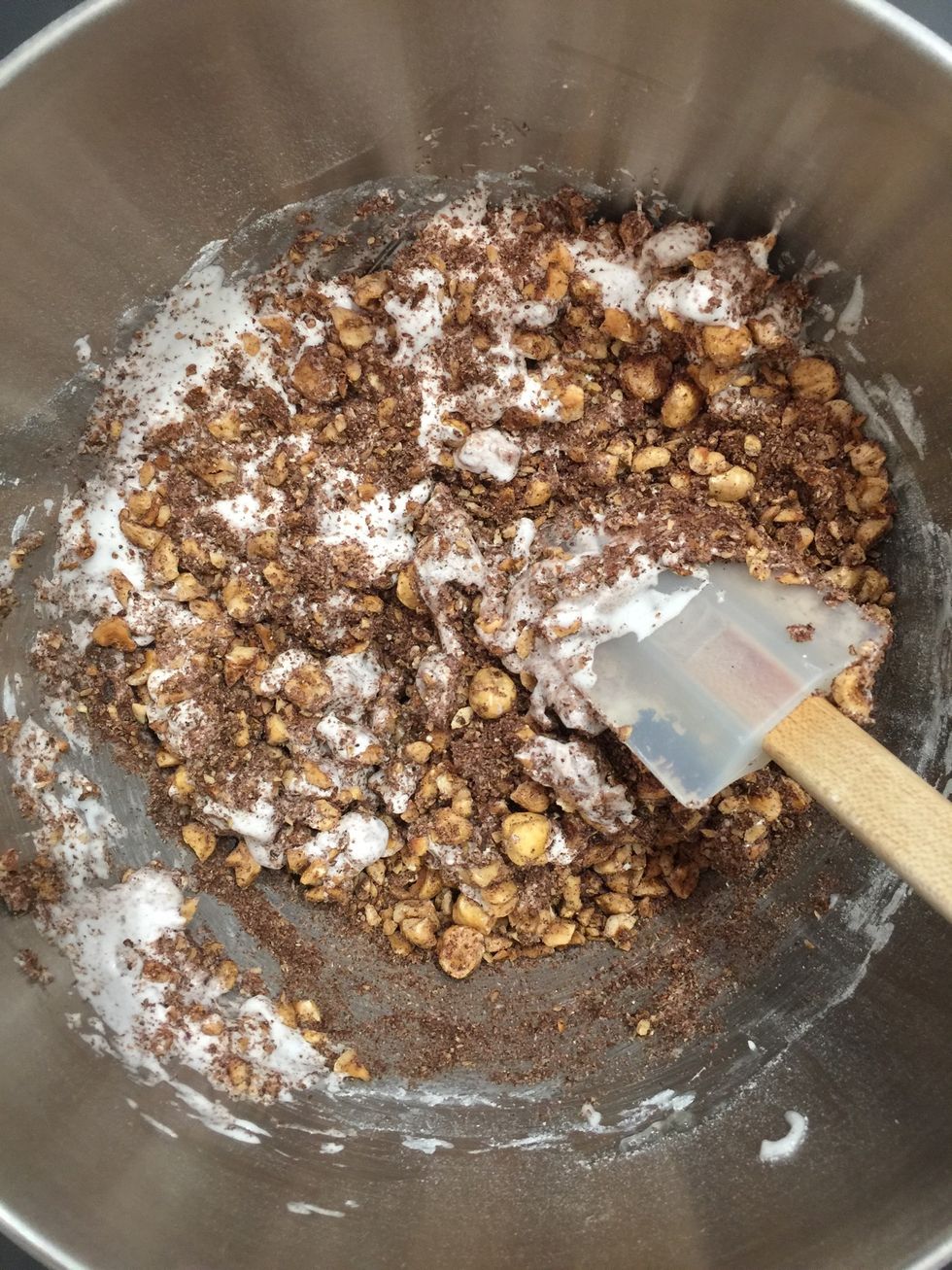 Beat the egg whites into soft peaks . Fold in the icing sugar and  the hazelnuts