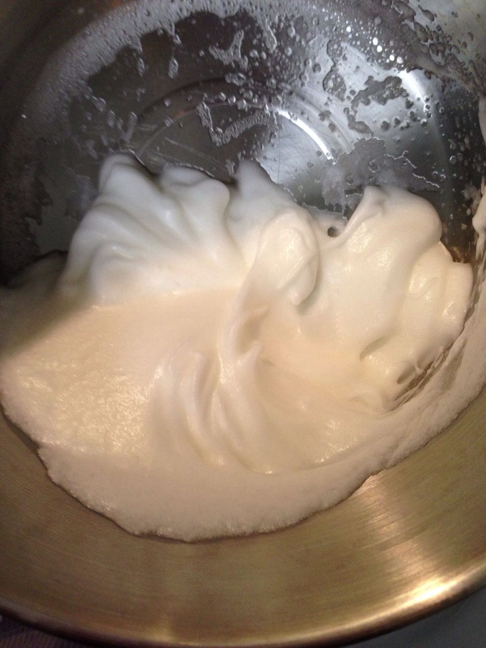Beat the egg whites with a whisk or electric mixer until they form soft peaks