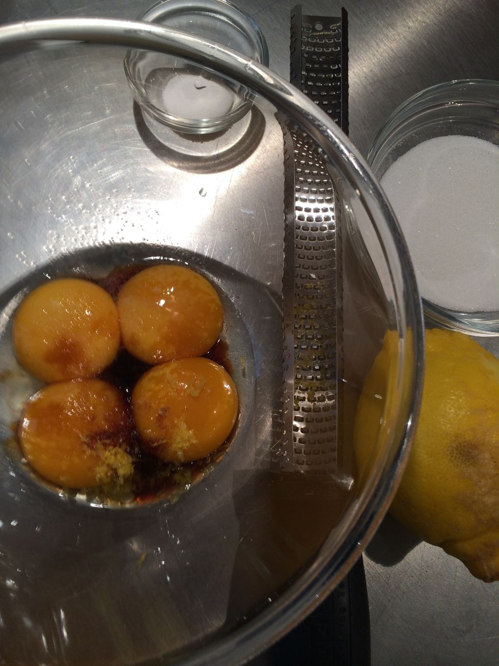 Beat the egg yolks with the sugar, vanilla, a pinch of salt and some lemon zest. Beat until they are light color