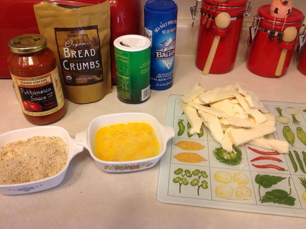Beat three large eggs in a bowl (these eggs are fresh from my hens). Place two cups of breadcrumb mixture in a bowl. Slice or shred the mozzarella.