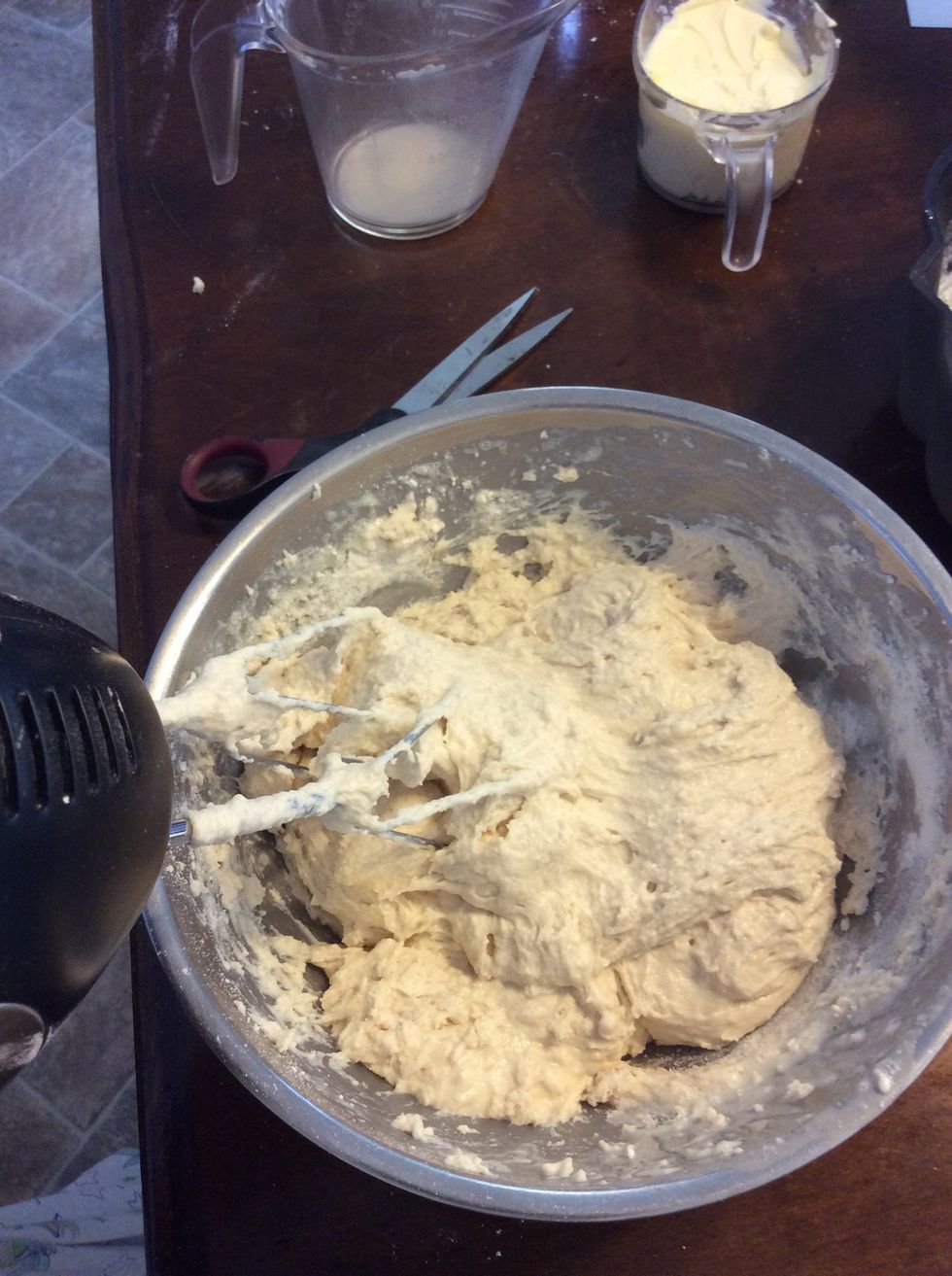 Beat with a hand mixture but be careful it will climb up your blender and you will have trying to get it off. The dough will be very sticky don't worry that is how it is supposed to be.