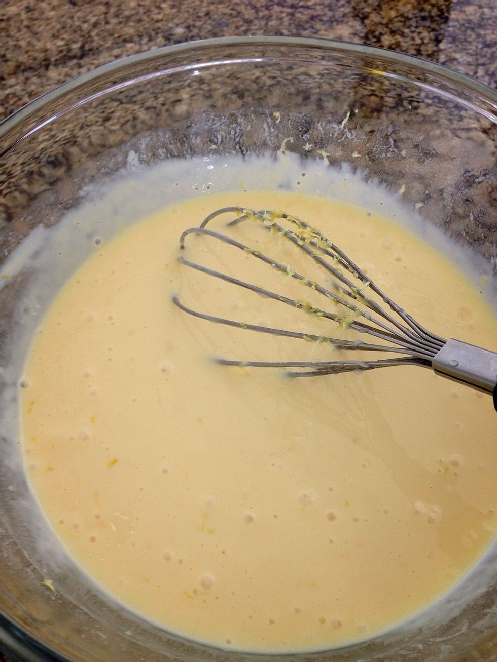 Beat your eggs first. Then add your condensed milk. After it's well incorporated , time for the key ingredient: lemon juice!! Add salt, baking powder, your tablespoon of flour, zest and food coloring.