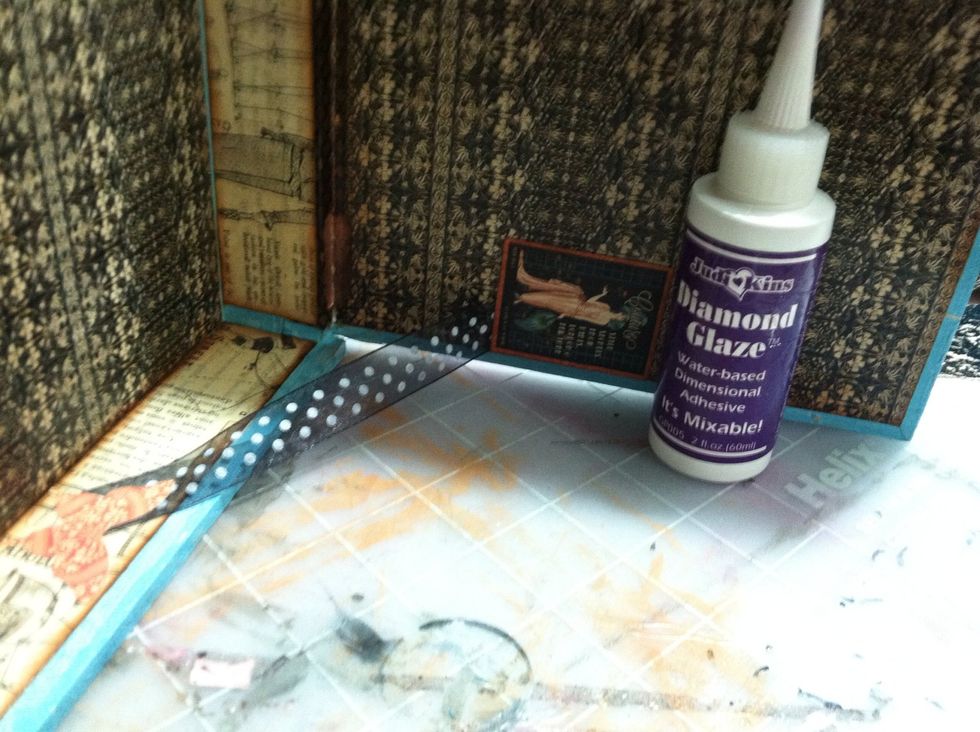 Because the lid of the box was opening all the way and causing the paper to crack, I made hinges inside using ribbon attached with Diamond Glaze adhesive.