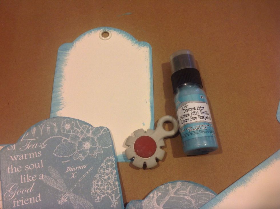 Before adhering the paper I'm edging the tags with distress paint.  Broken china paint matches so sweet with this paper. Also distress edges with distressing tool.