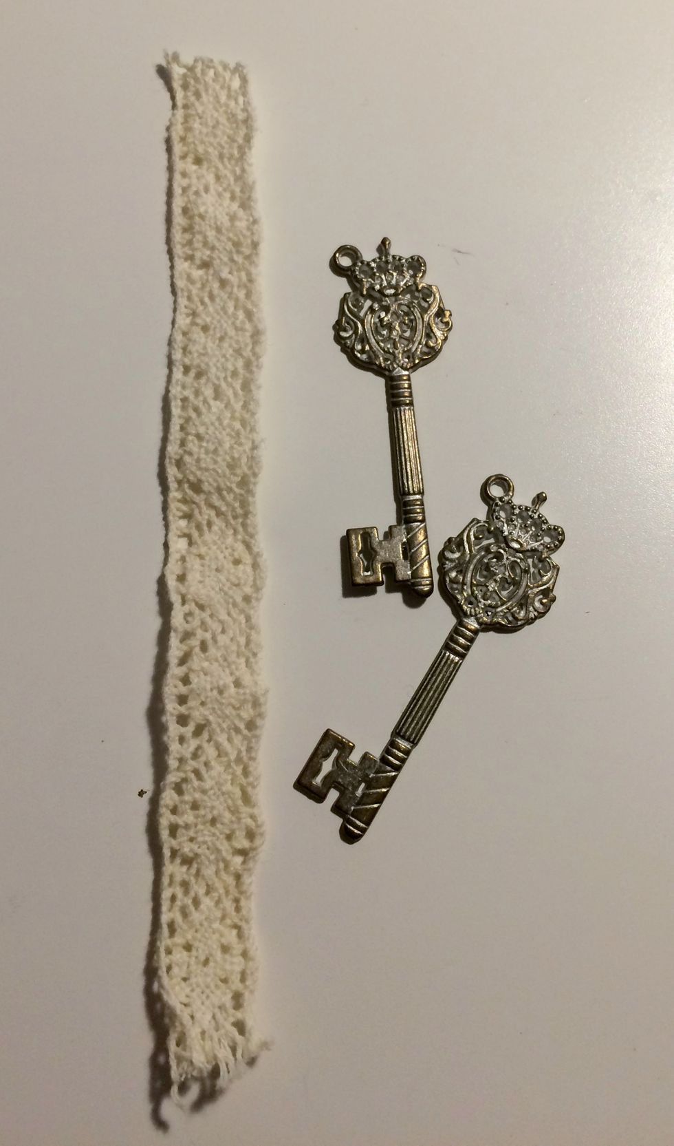 Before assembling the card, choose two shabby chic metal keys and cut a piece of crochet trim to 4 7/8".