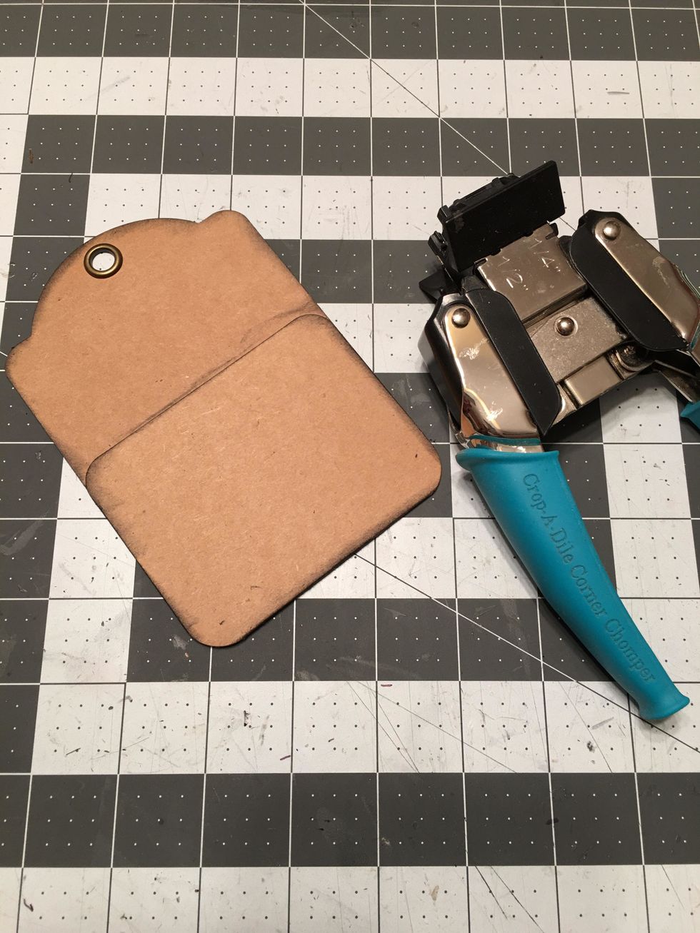 Before attaching the patterned paper, you need to also round the bottom corners of the tags with the pocket so it will look like this. Ink the edges with black soot Distress Ink.