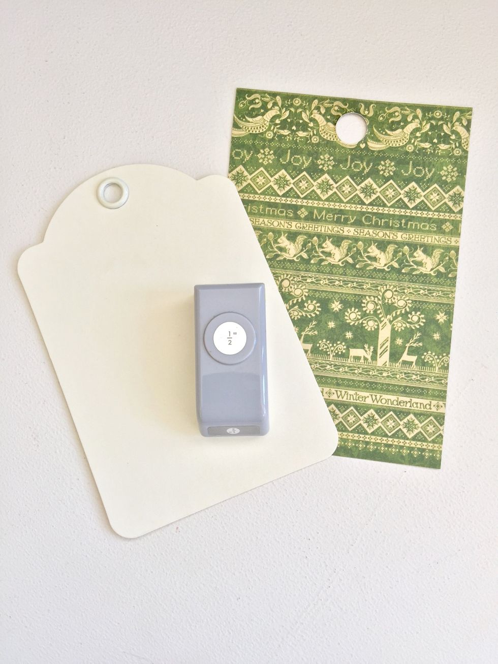 Before cover and glue paper on the tags, punch a 1/2" hole.