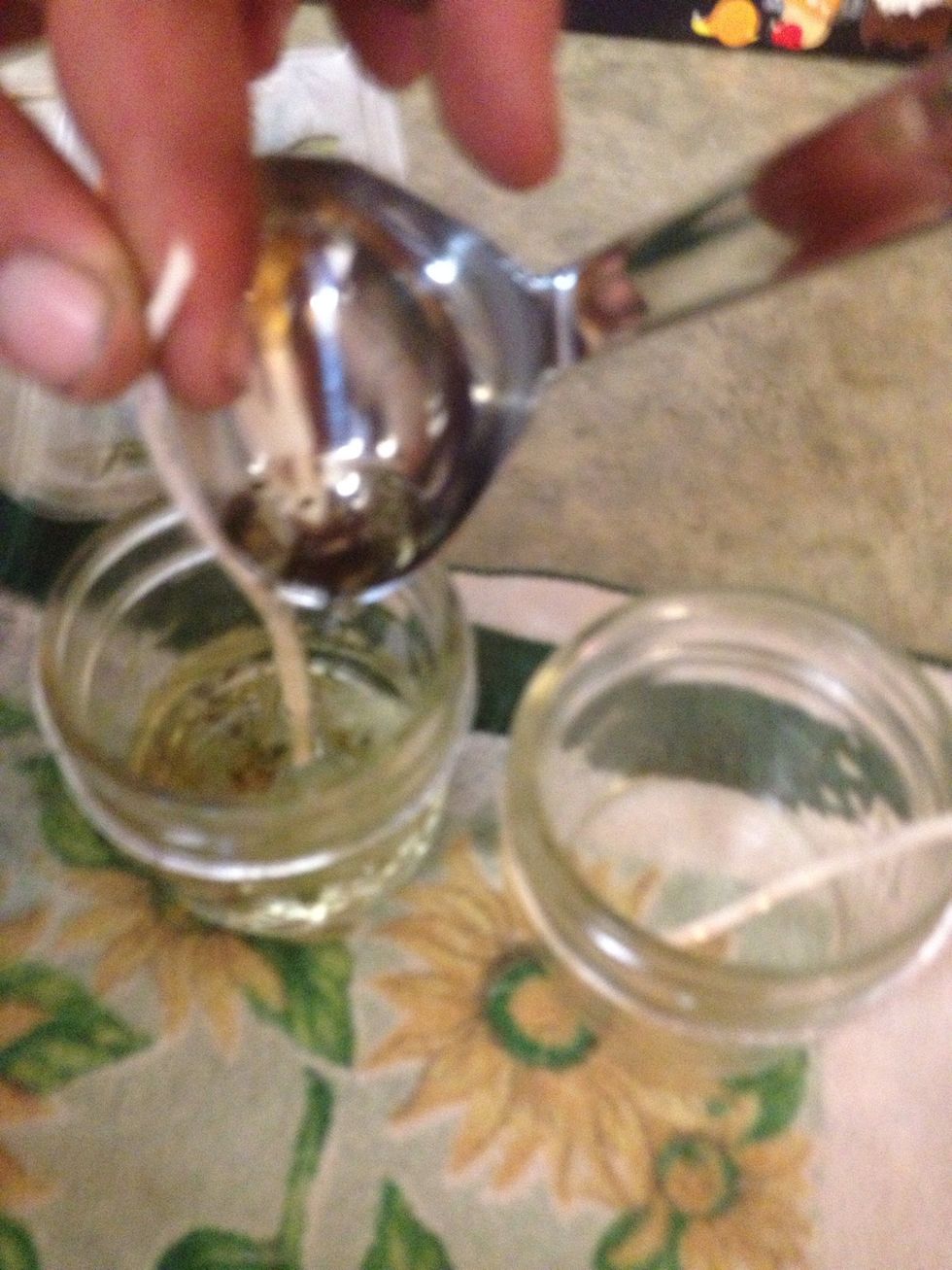 Before the wax cools, ladle the mixture into your mason jars - holding the wick up a bit.