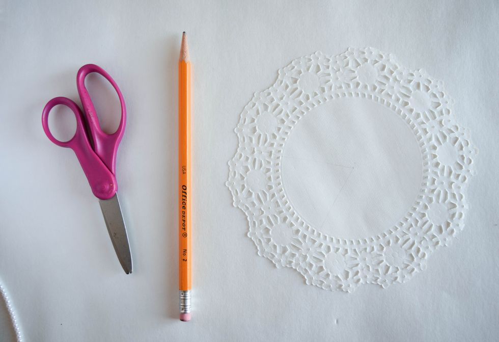 Before using a doily, make a test piece using scrap paper to experiment with different sizes and dress shapes.