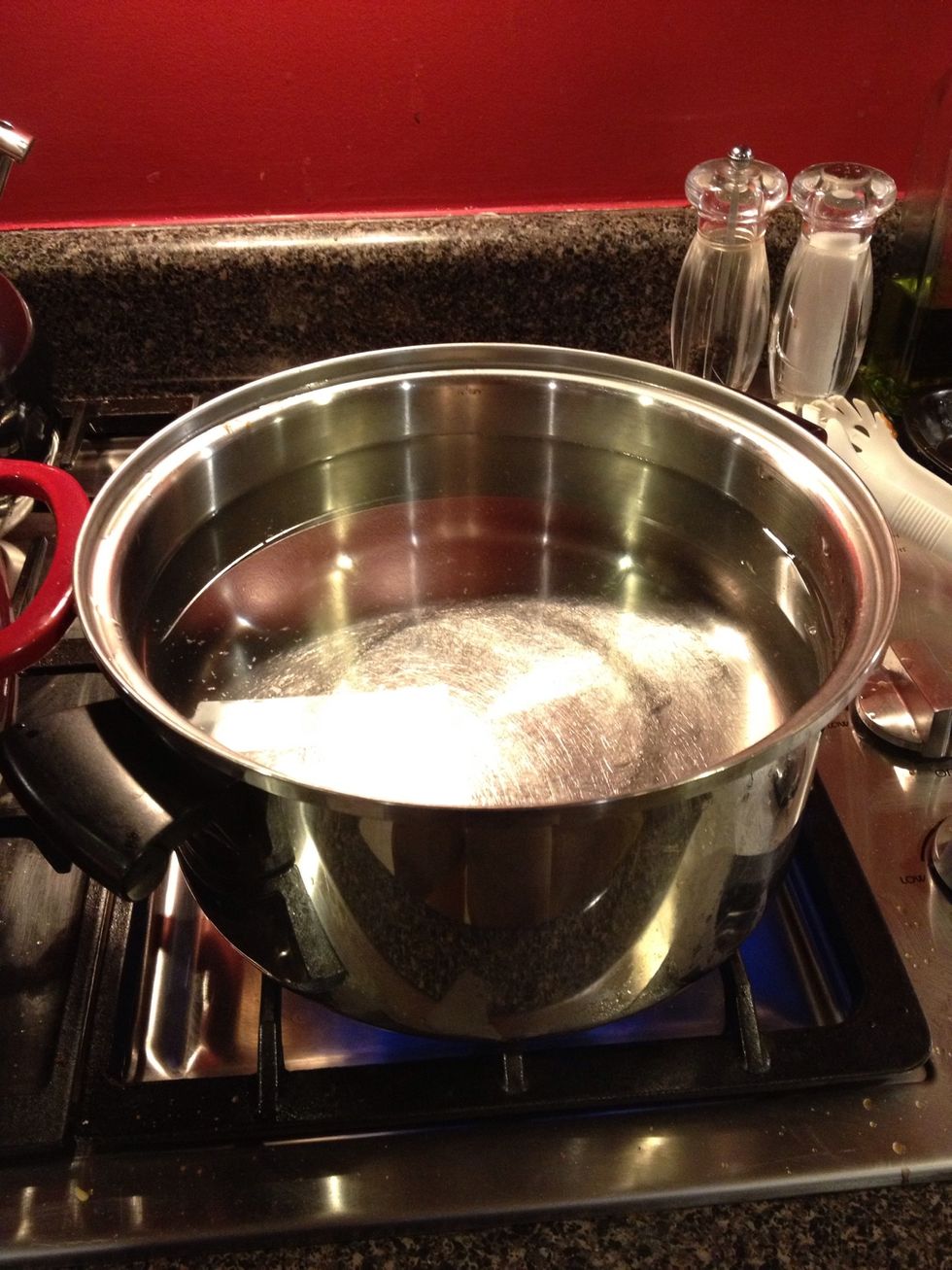 Before we fill jars, fill a large pot with water and put it on the stove so it can start heating up. We need the water to be boiling.