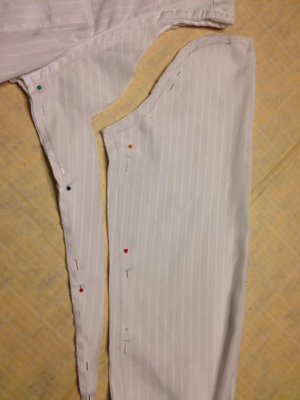 Before you cut!! pin the sleeves together on the other side of the pencil line!! Remember that you must leave 1/2 inch for seam allowance. Then cut it!!