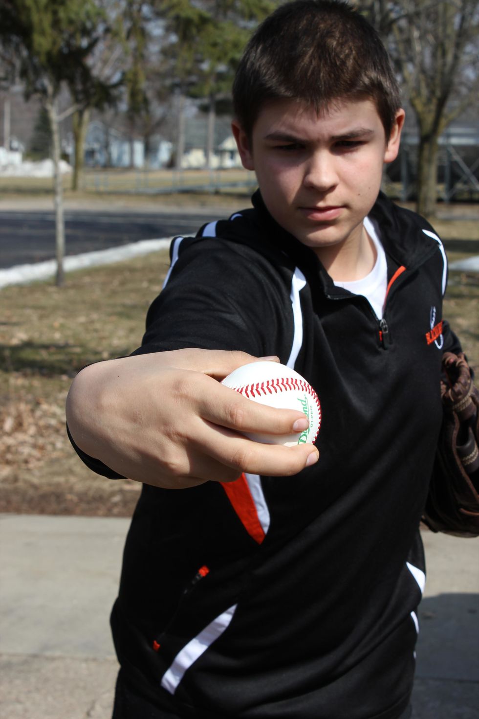Before you release the ball, your thumb should be facing your face and your wrist is slightly cocked in