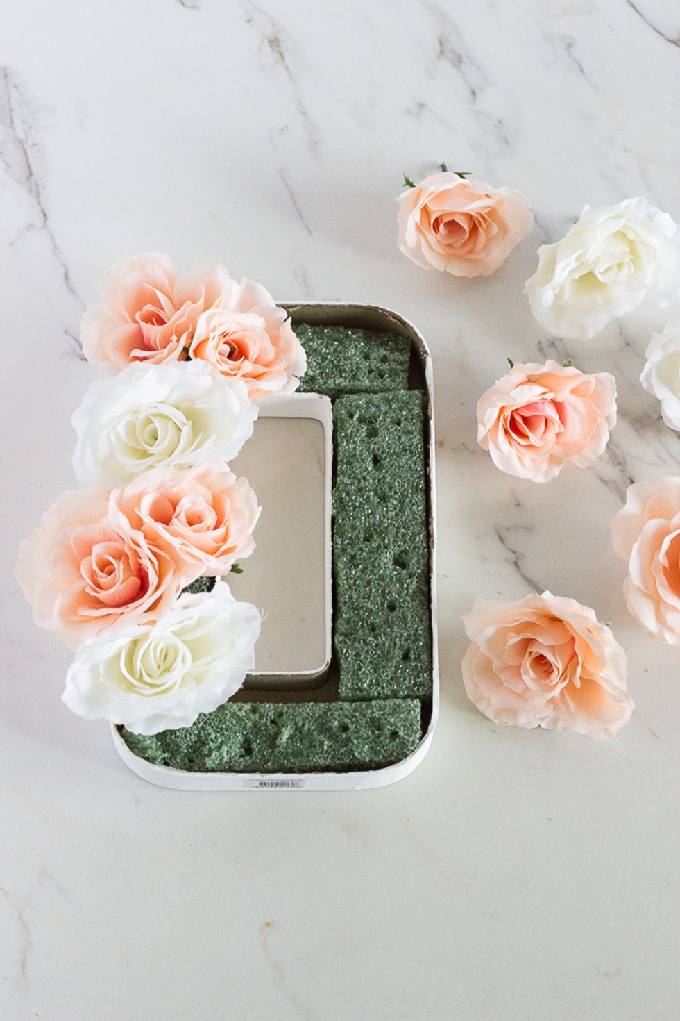 Before you start sticking in your flowers, make sure you cut off all the stems so that only a tad of the stem stays on, just enough so that you can stick them into the floral foam.