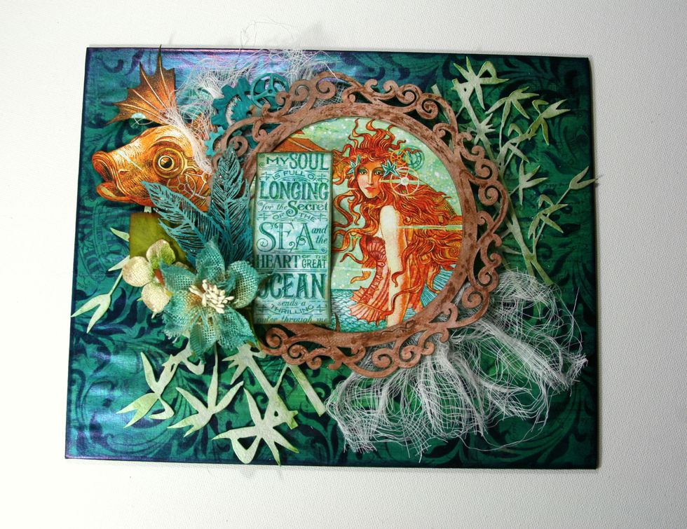 Begin adding Petaloo Flowers and prepared Gypsy Soul Laser Cut Feather chippies.