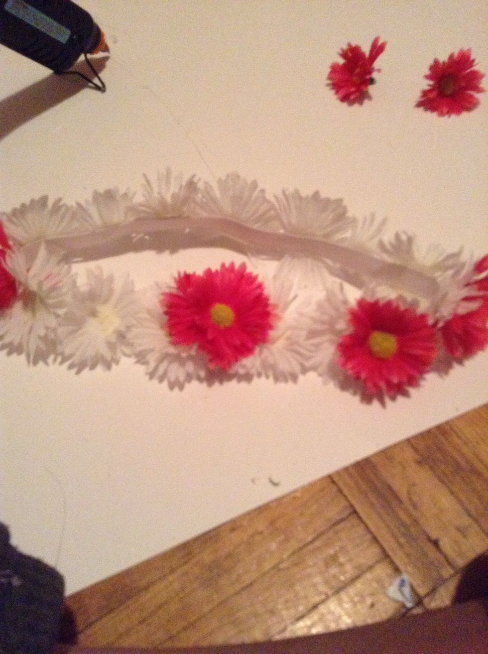 Begin adding the full flowers to the front ONLY. YOU MAY CUT OF THE CYLINDERS AT THE BACK OF THESE for an easier step. Sorry for the blurry picture.