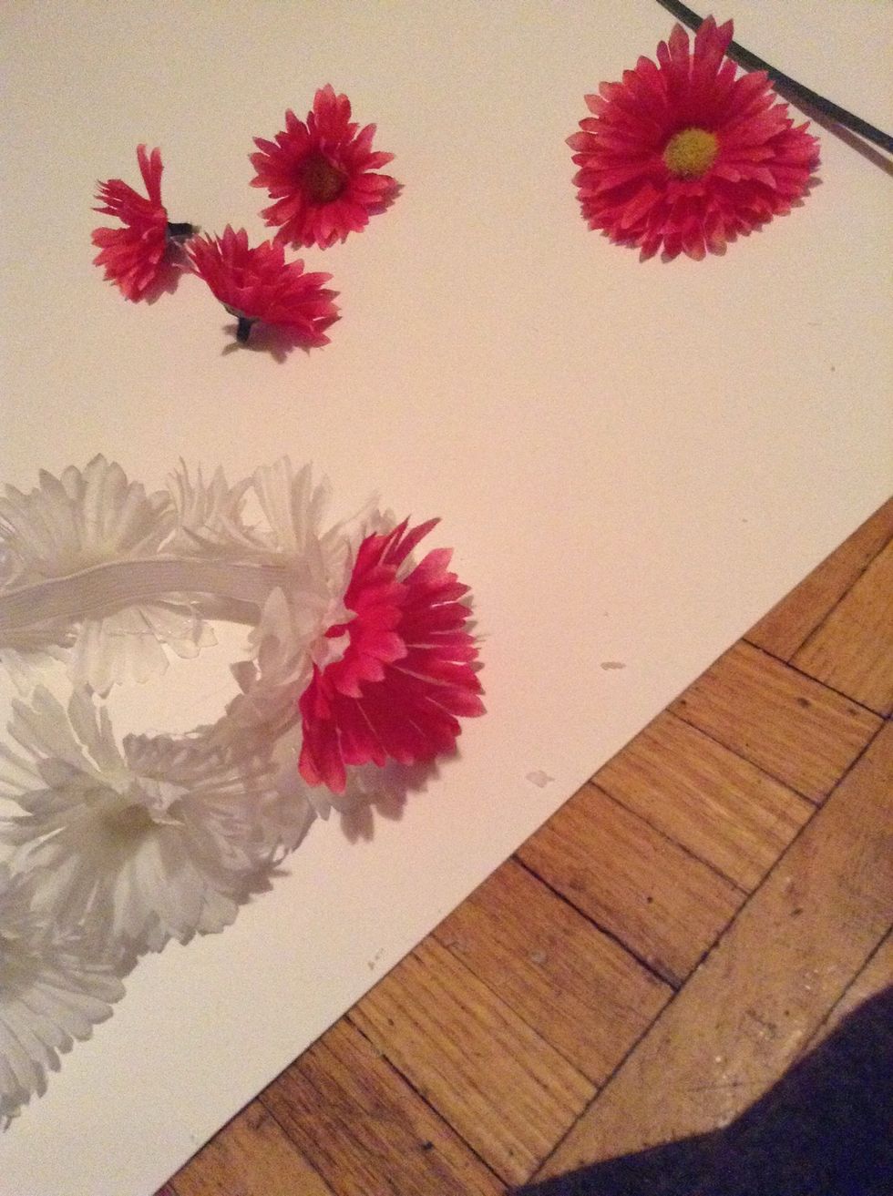 Begin adding the separated pink/second colour flower's layers on either side of the head band. We are adding a pop of colour to the headband with a second colour, but for a simple look leave only one.