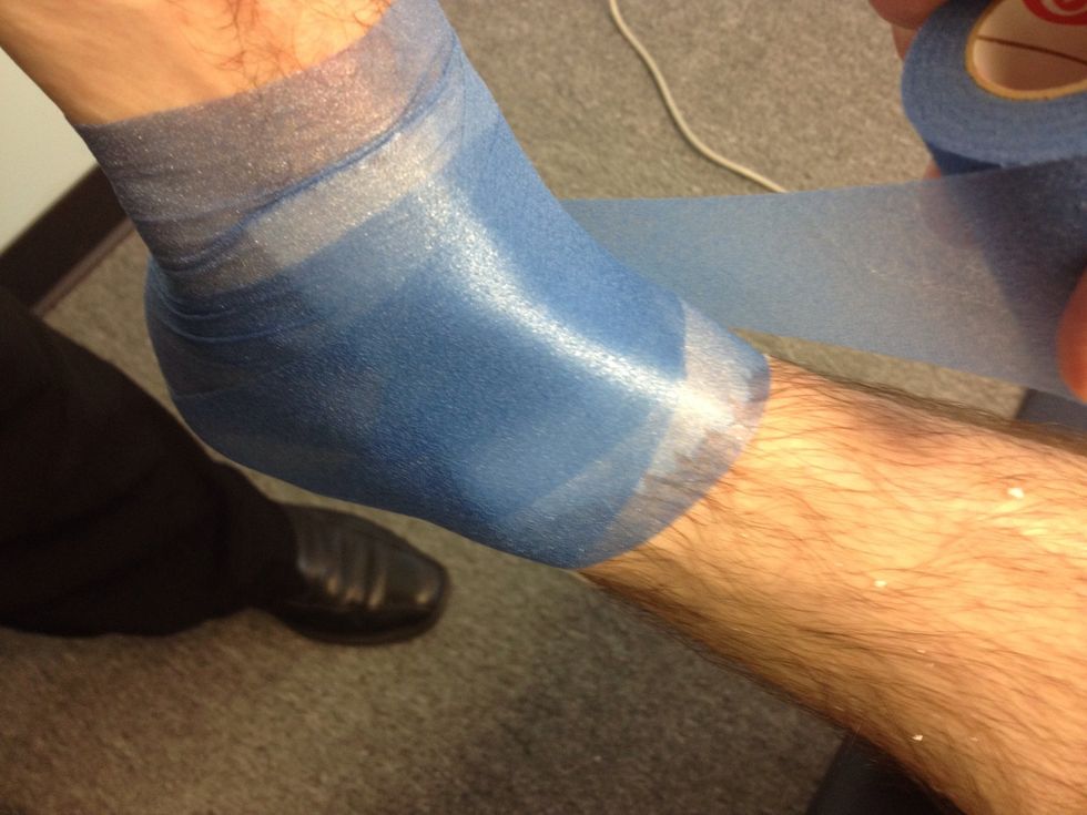 Begin at the toes spiral the prewrap around the bottom of the foot continue up the leg ending just below the calf muscle.