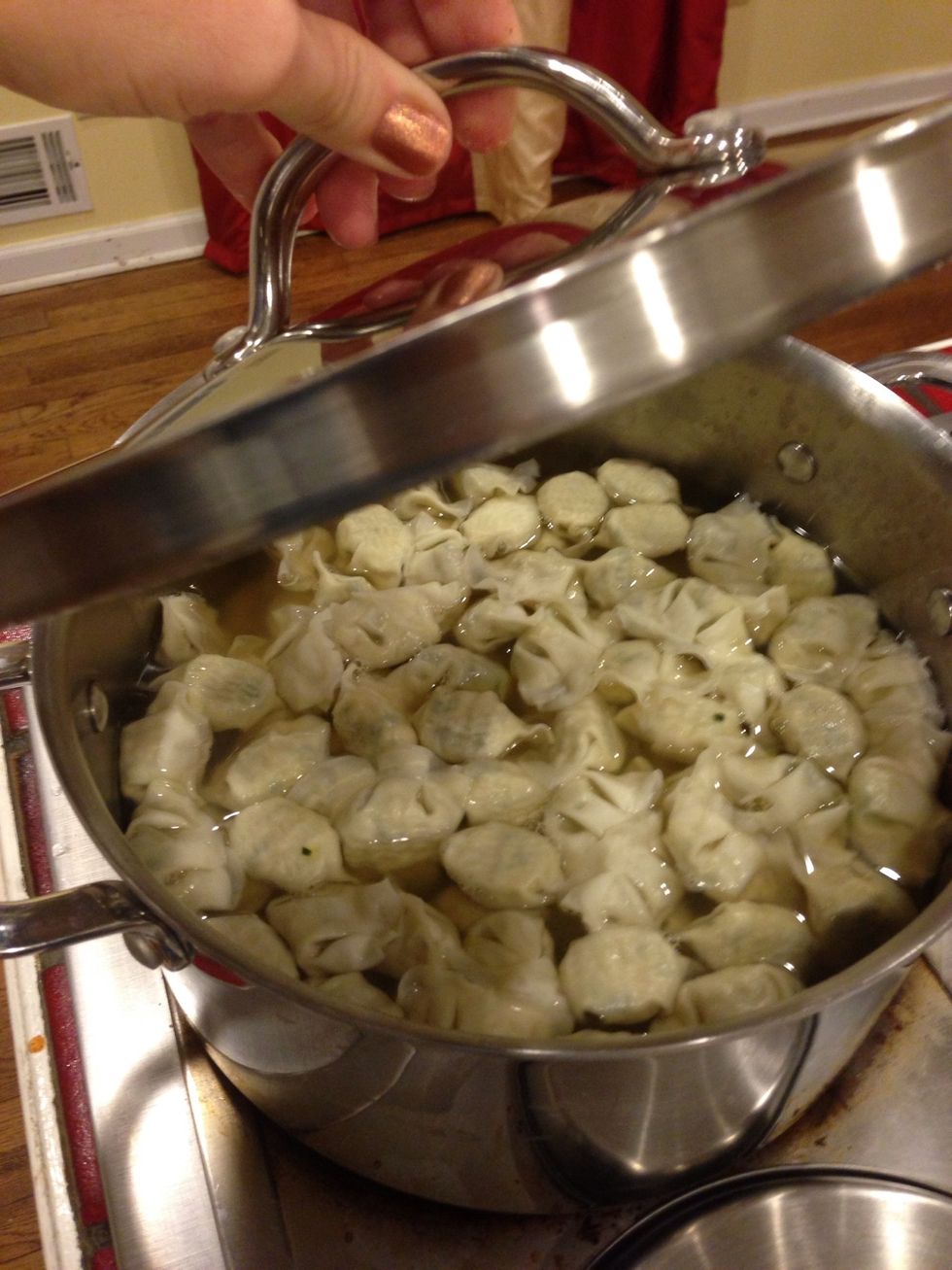 Begin boiling water with bouillon cubes. When water reaches boiling, add won ton and cook for about 5 minutes.
