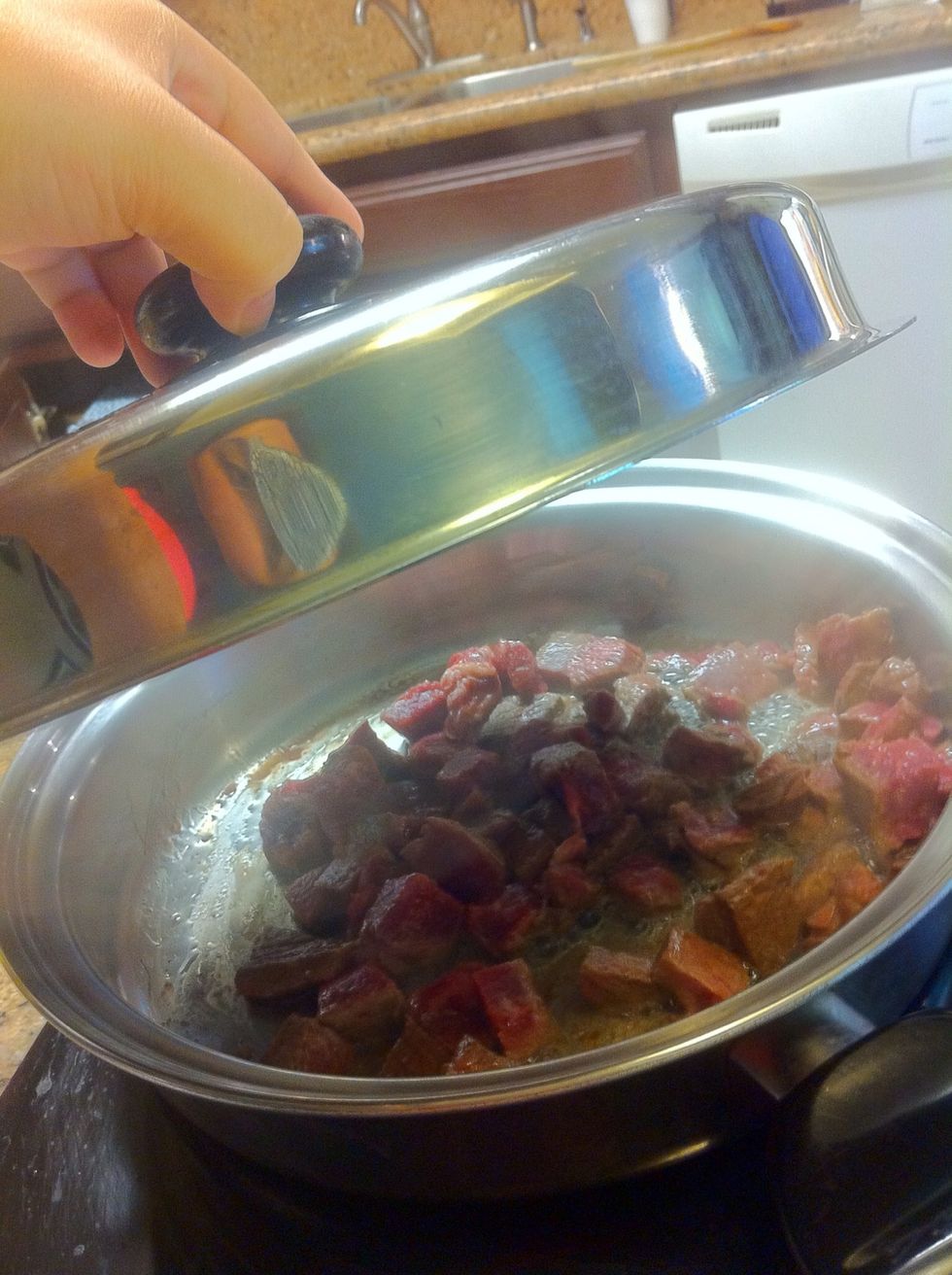 Begin browning the beef and cover.