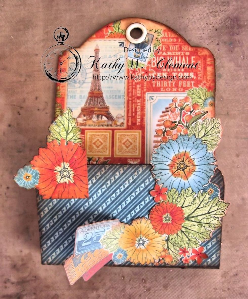 Begin building layers with these pieces, gluing directly to the pocket base.  Leave the tickets unglued as seen in the photo.
