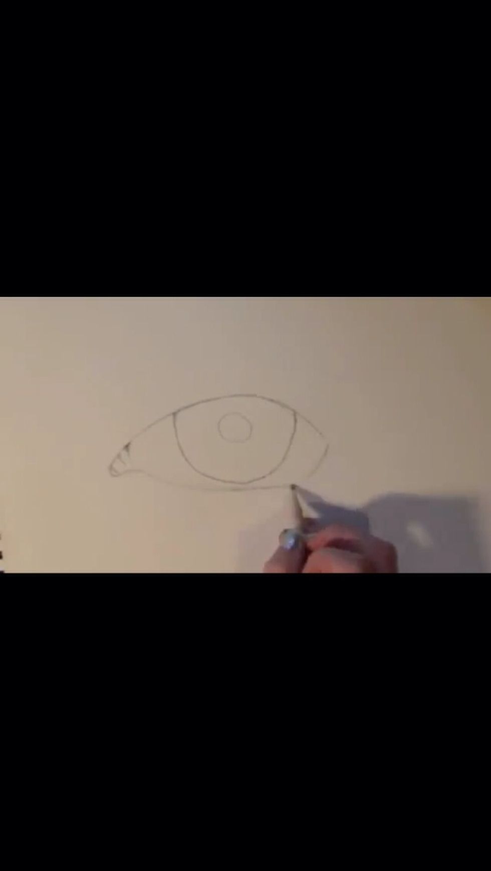 Begin by drawing a lemon shape-NOT AN OVAL! Sketch in a circle for the iris. However, it is not a full circle, part of it is covered by skin
