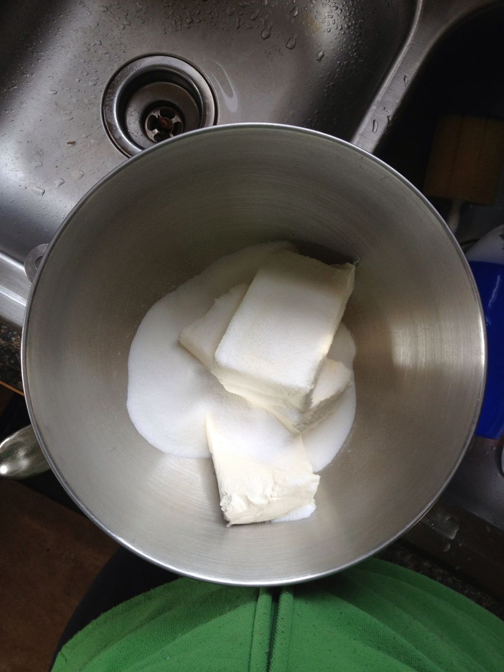 Begin by placing the sugar and cream cheese in a mixing bowl. It is VERY IMPORTANT that your cream cheese is room temperature. Take it out a few hours ahead of time. Overnight even.