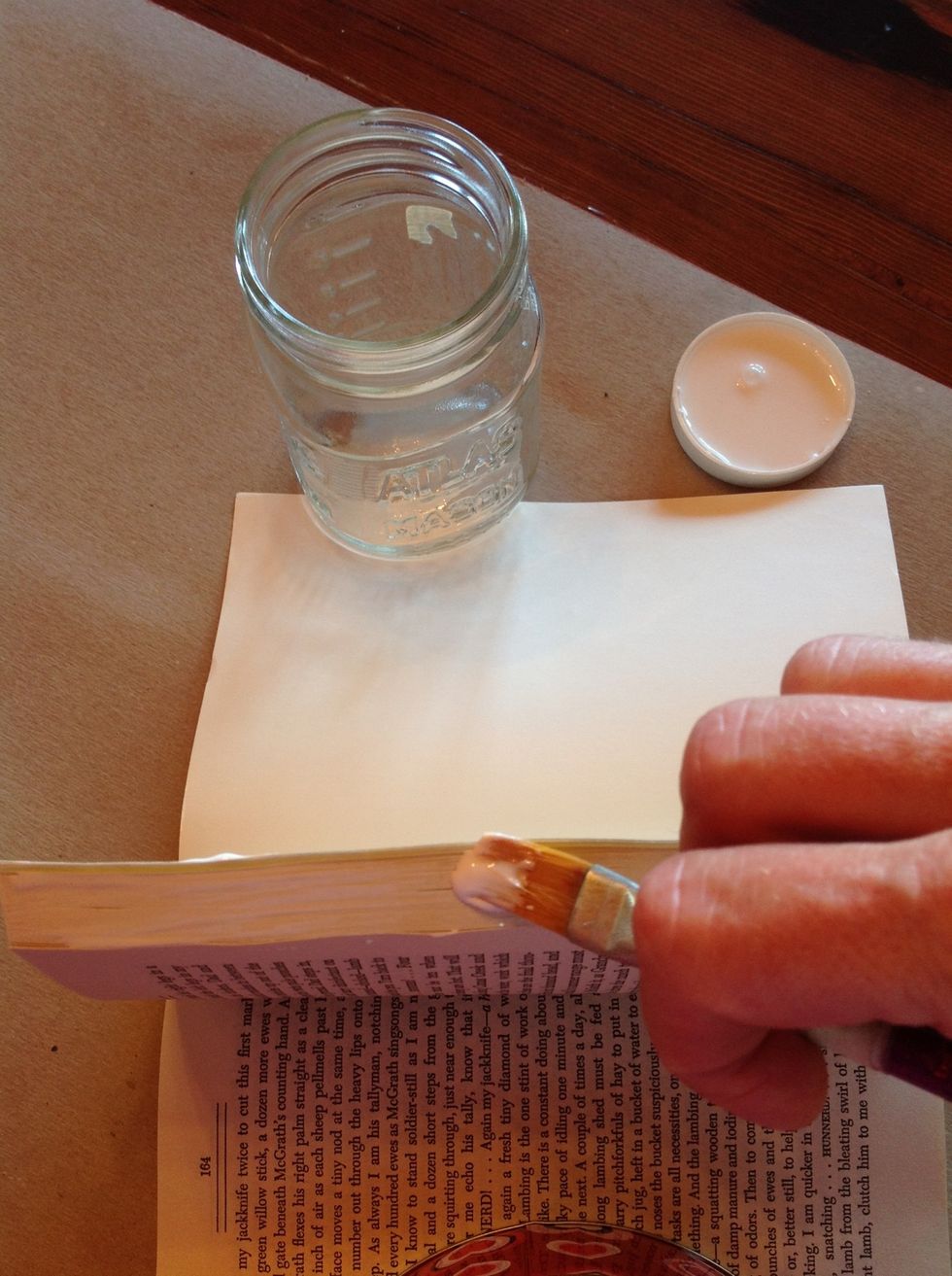 Begin by selecting a group of pages for you shadow box. The thickness of this group will determine the depth of your box. Apply white glue or gel medium to the sides and top of the group.