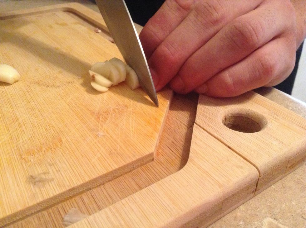 Begin by slicing garlic thin