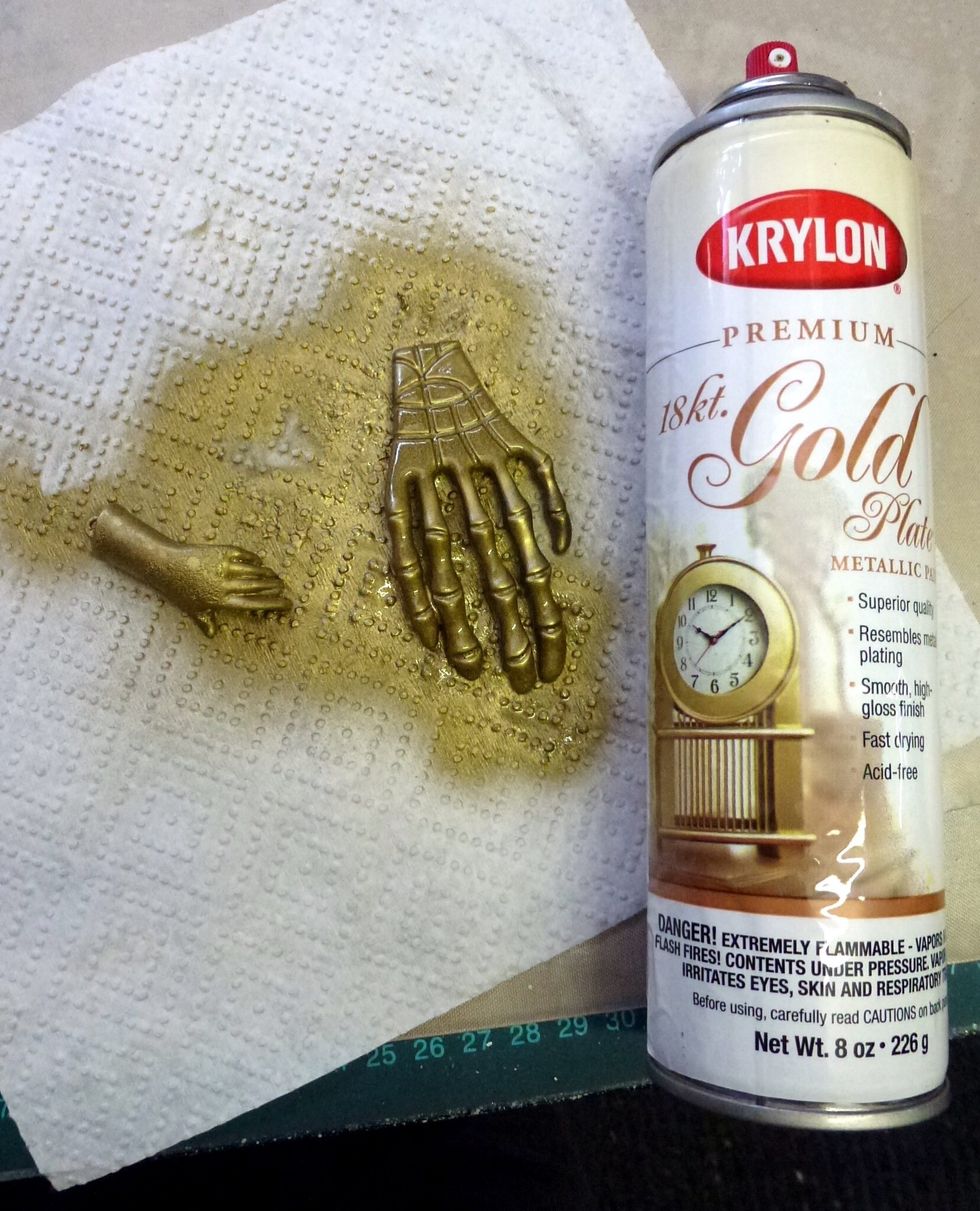 Begin by spray painting both the metal hand and resin cast hand. The metal hand will be the base. When dry adhere the resin cast hand on top of the metal hand using strong clear drying glue
