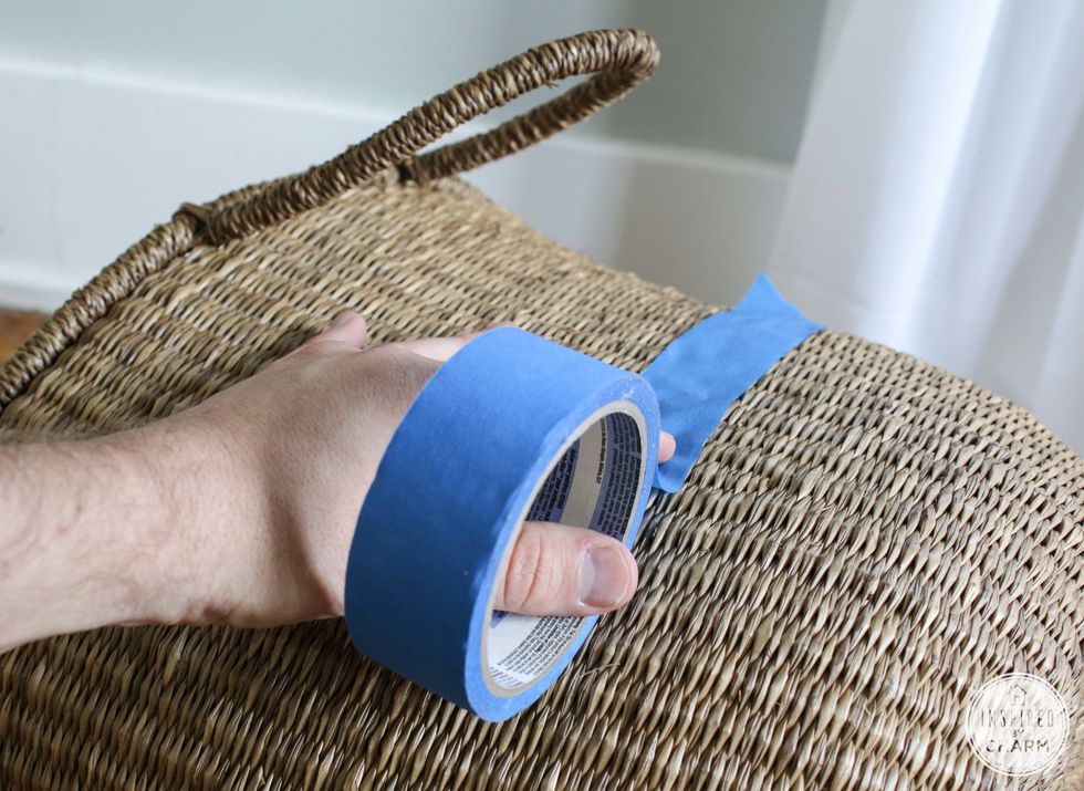 Begin by taping off your basket. This will act as a guide of where to put your paint. I went with a diagonal line to give the basket a dipped-in-paint look.