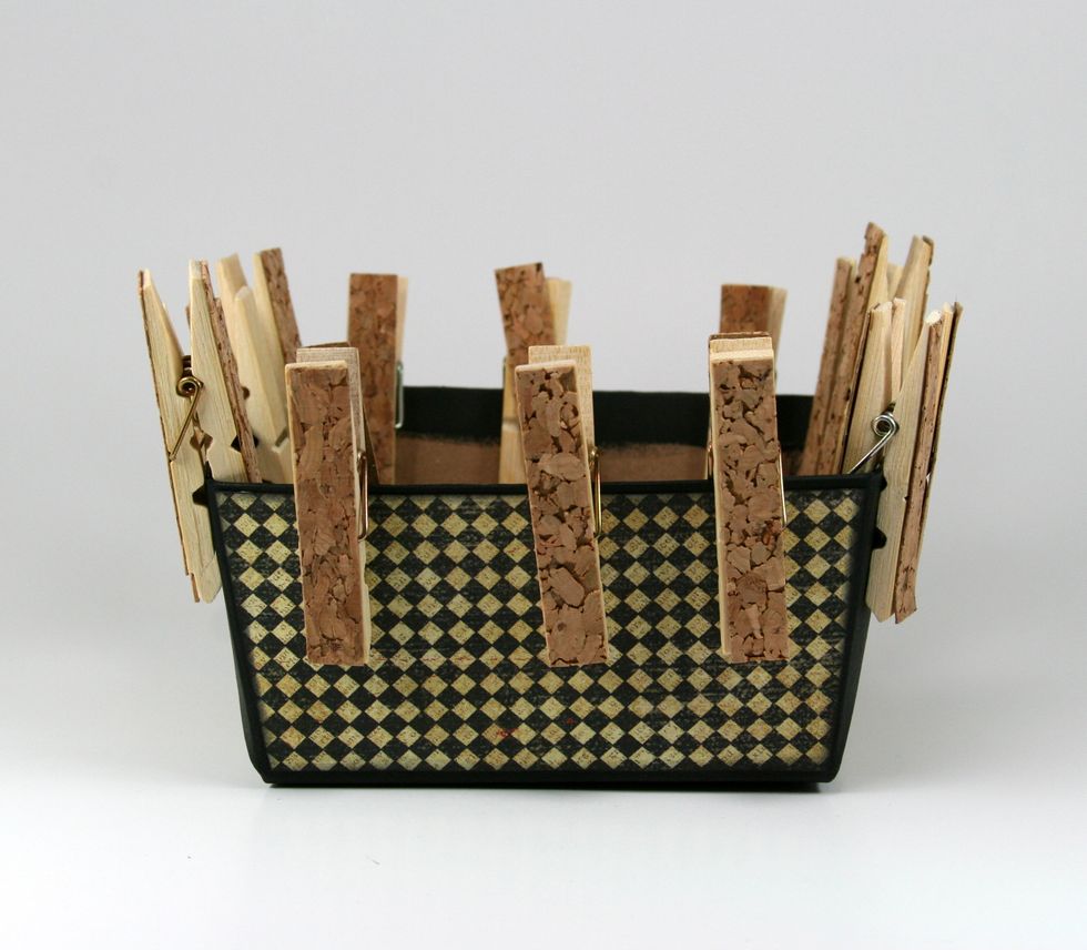 Begin covering with patterned papers.  I used a wet adhesive to ensure a good bond so I secured the paper with clothespins while the glue sets up.