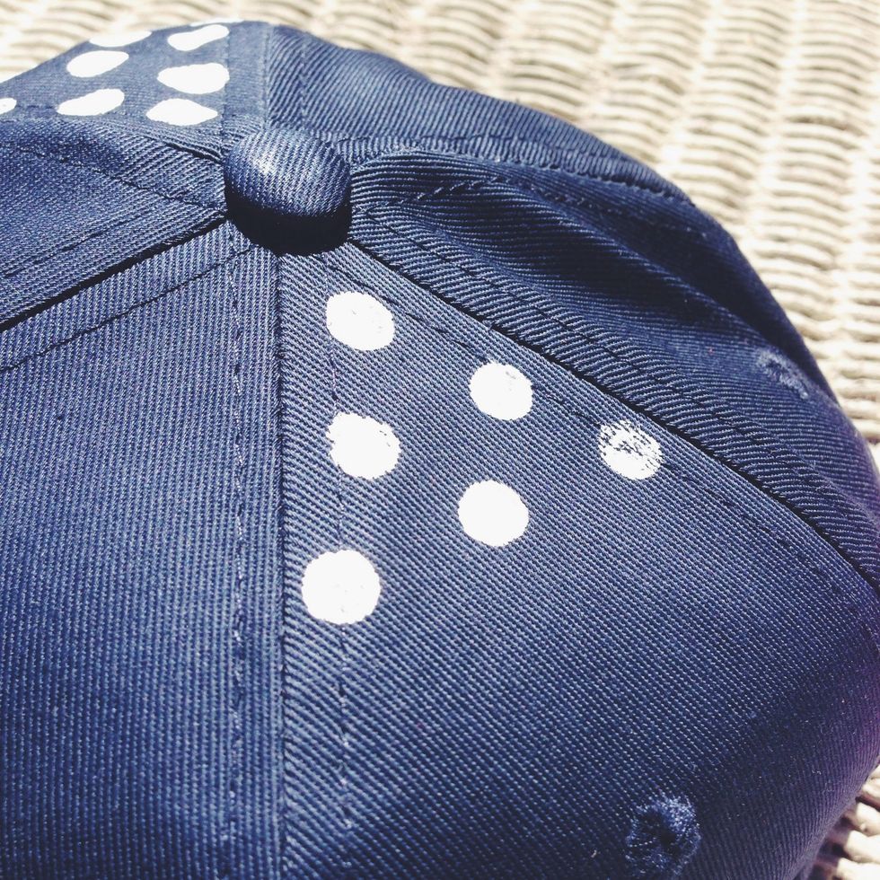 Begin evenly dotting your baseball cap to create a pattern. I placed the rows equally apart and centered lower dots between the row above. Try to keep this uniform pattern all around the cap.