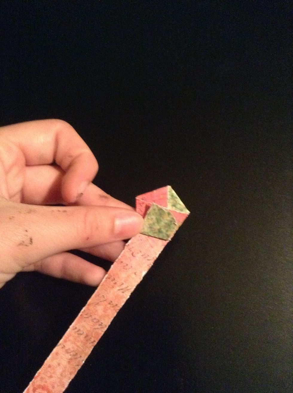 Begin folding the paper, letting the hexagon's edges guide you.