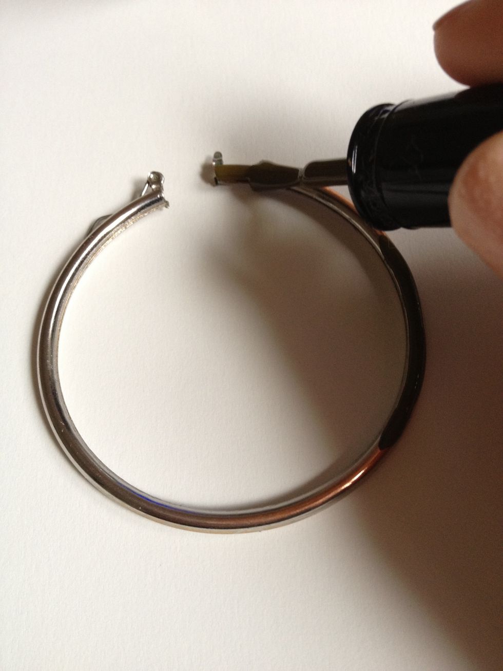 Begin painting one side of the earring with one coat