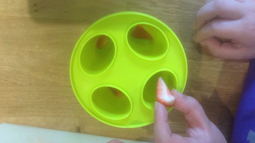 Begin placing your fruit into your moulds