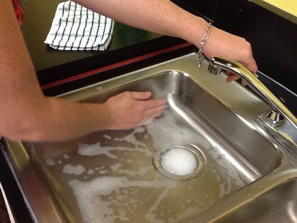 Begin rinsing out sink. Use cold water and your hand to help bubbles go down.