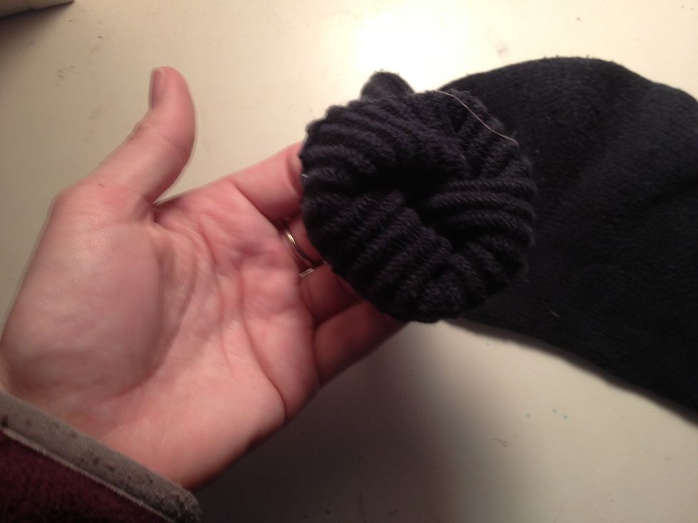 Begin rolling the sock from the top by folding over the seam.