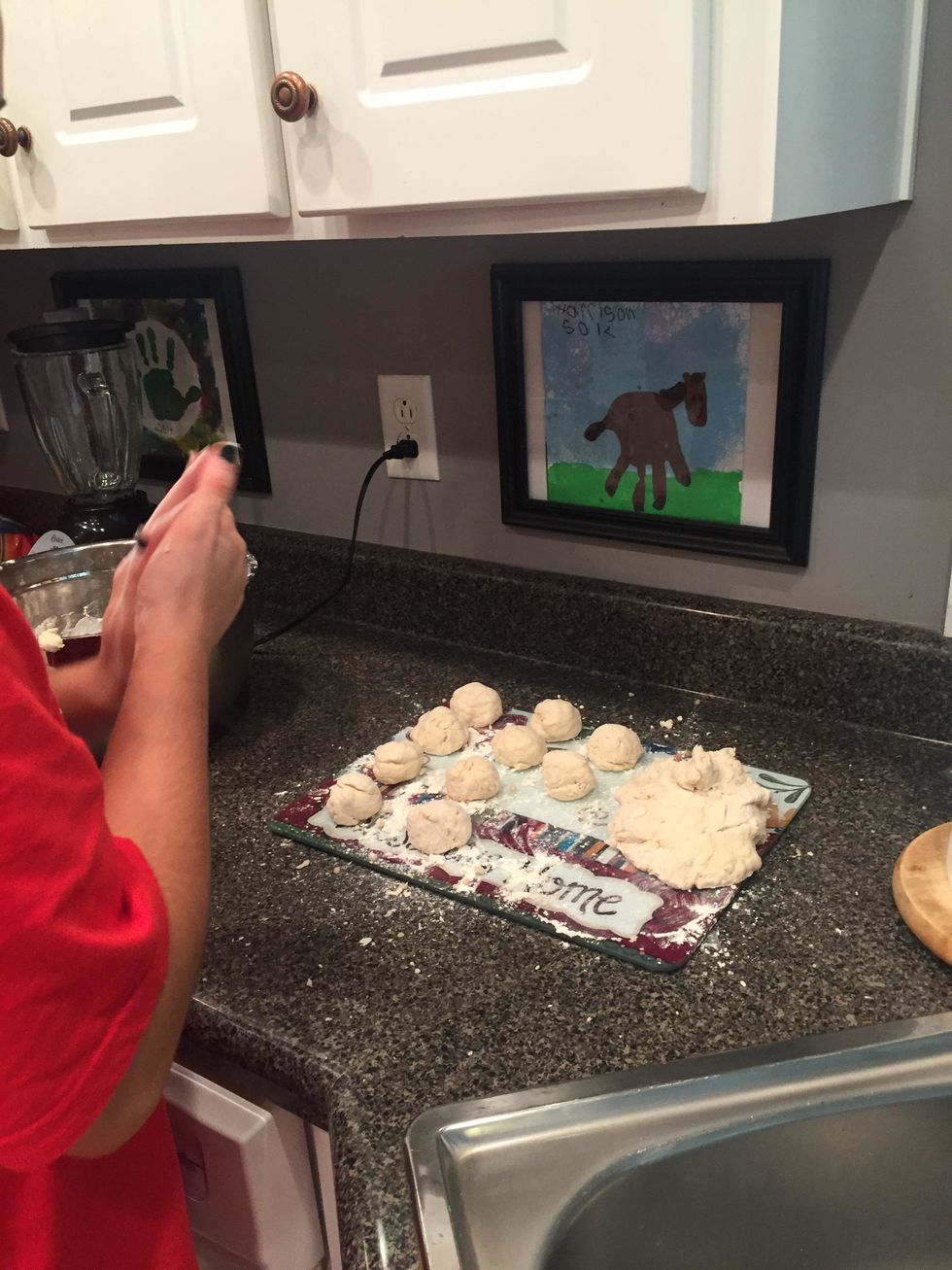 begin separating the dough and making it into 20 small balls