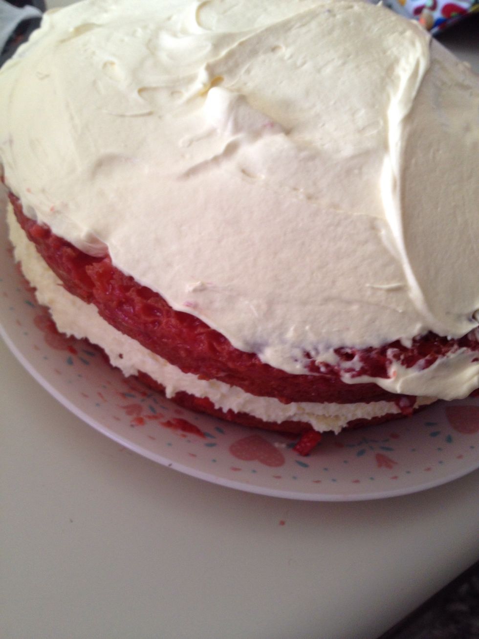 Begin spreading your whipped pudding topping all over your cake.