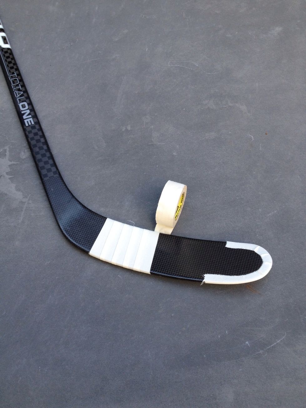 Begin taping by wrapping the tape around the blade slightly overlapping the previous strip. This should be a continuous piece of tape.