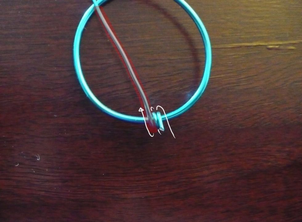 Begin the wrap by tightly coiling the thin wire twice over the frame.