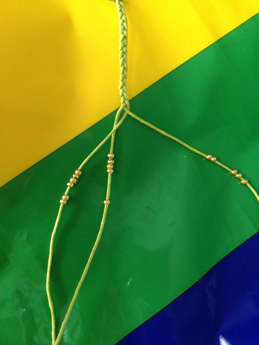 Begin threading through the beads. Should be 13 on the first strand, 14 on the second and 13 on the last.