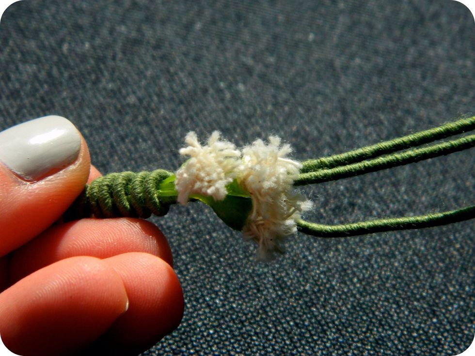 Begin to add your flowers by wrapping them at the stem with a new wire.