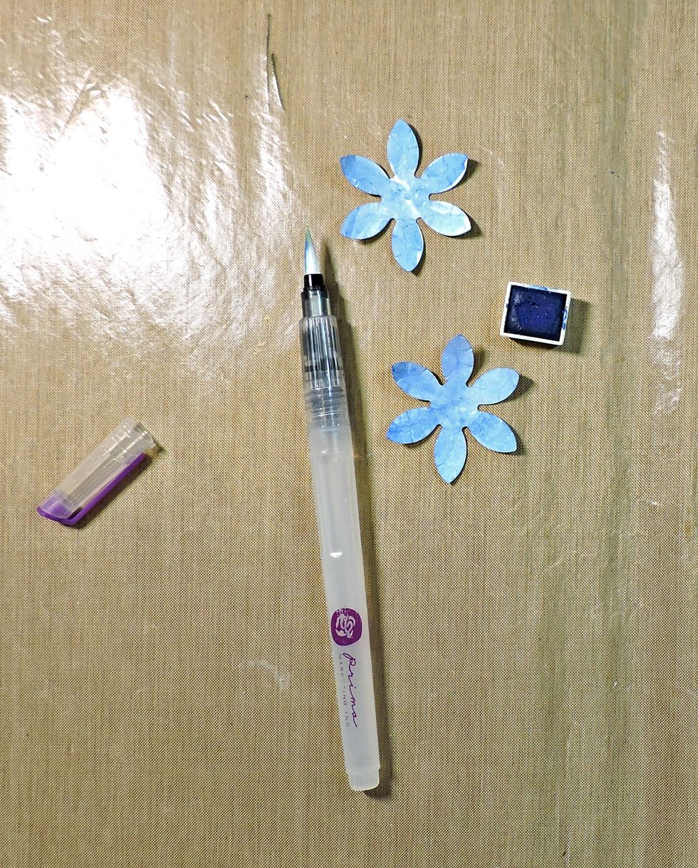 Begin to color your shapes, saturating both sides. (No need for perfection; you want the petals to be varied.) Dry completely; you may want to use a heat tool to speed things up.