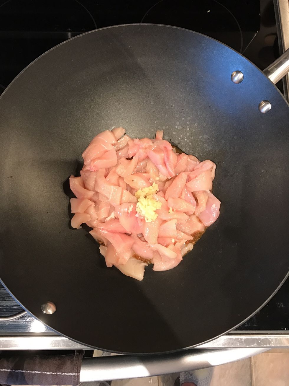 Begin to cook salad dressing, chicken, and garlic